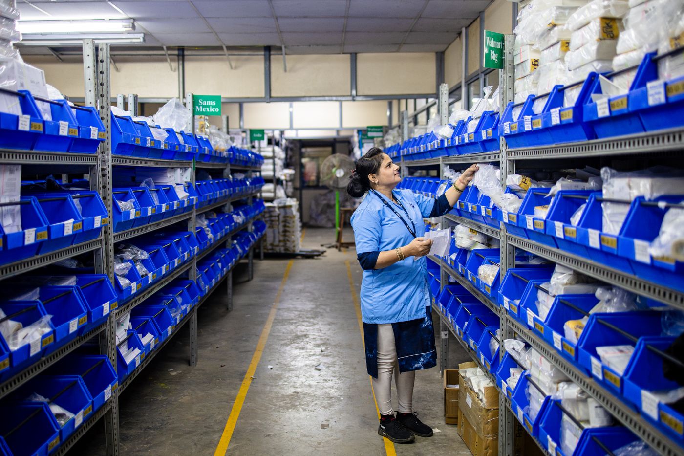 A warehouse worker picking an order from the shelves