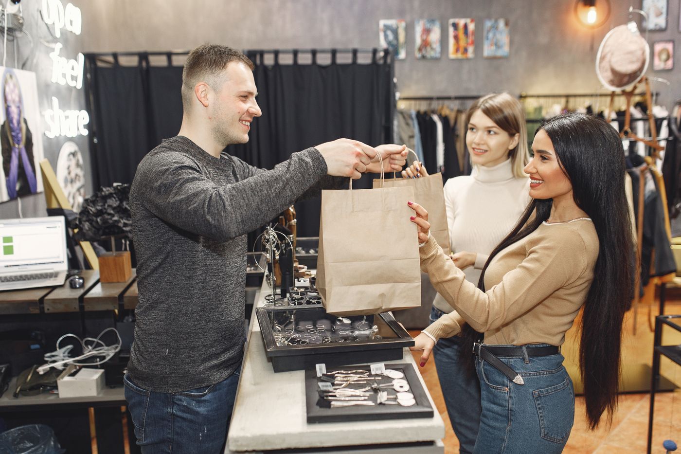 A shop assistant handing over an order at the counter