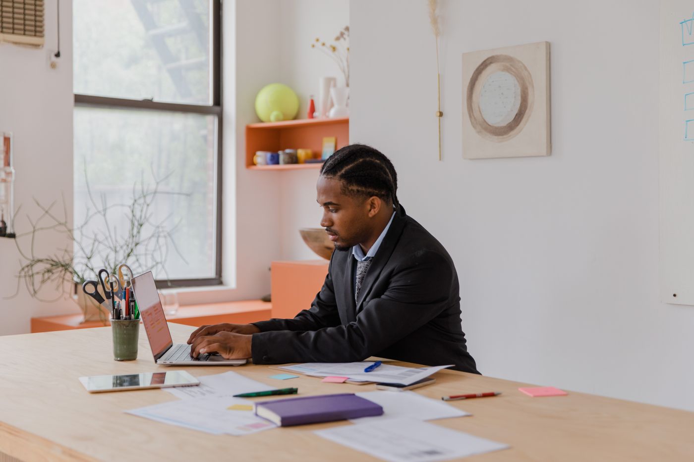 A finance officer reconciling payouts at a laptop