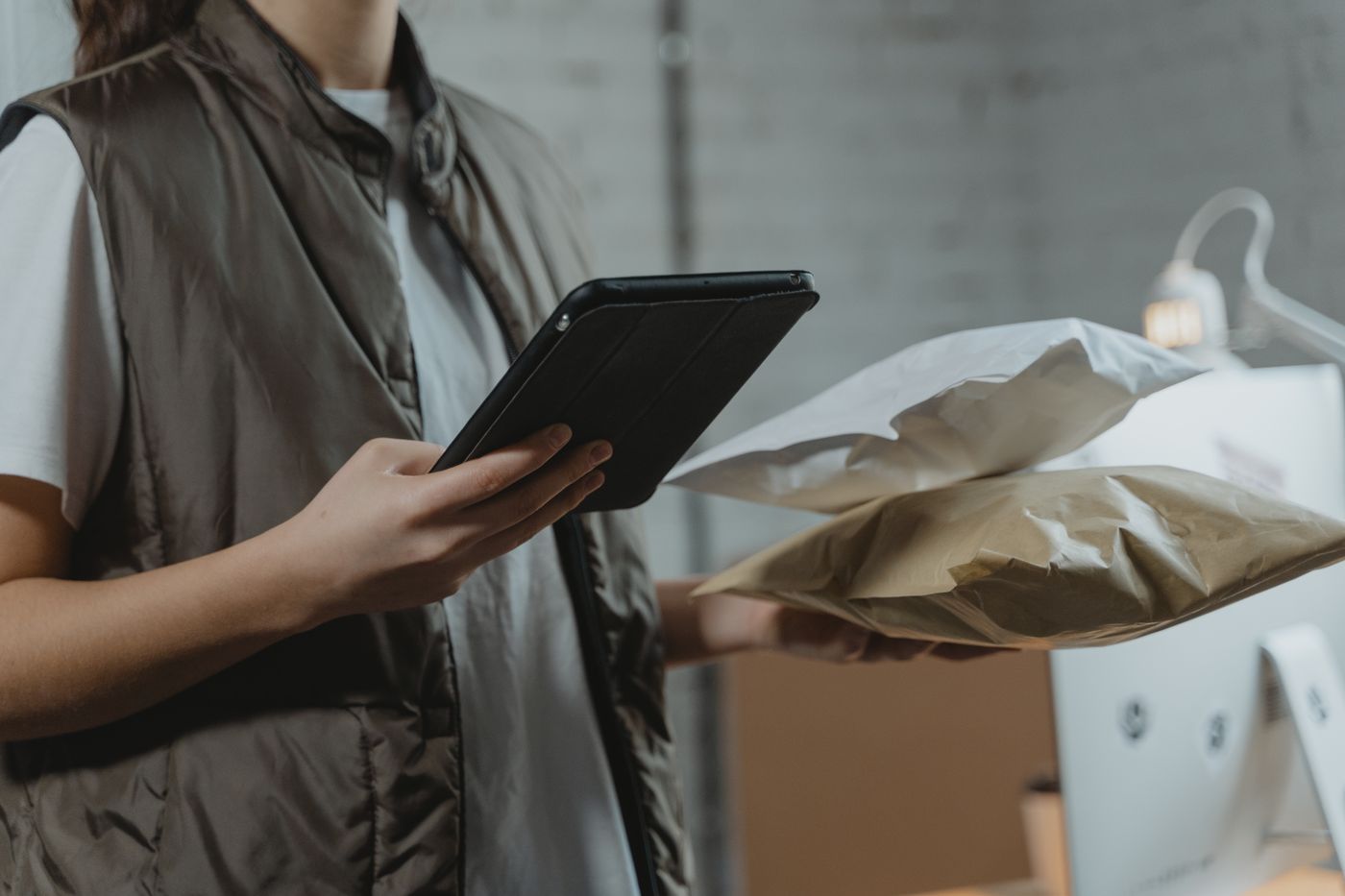 A worker checking parcels against a tablet